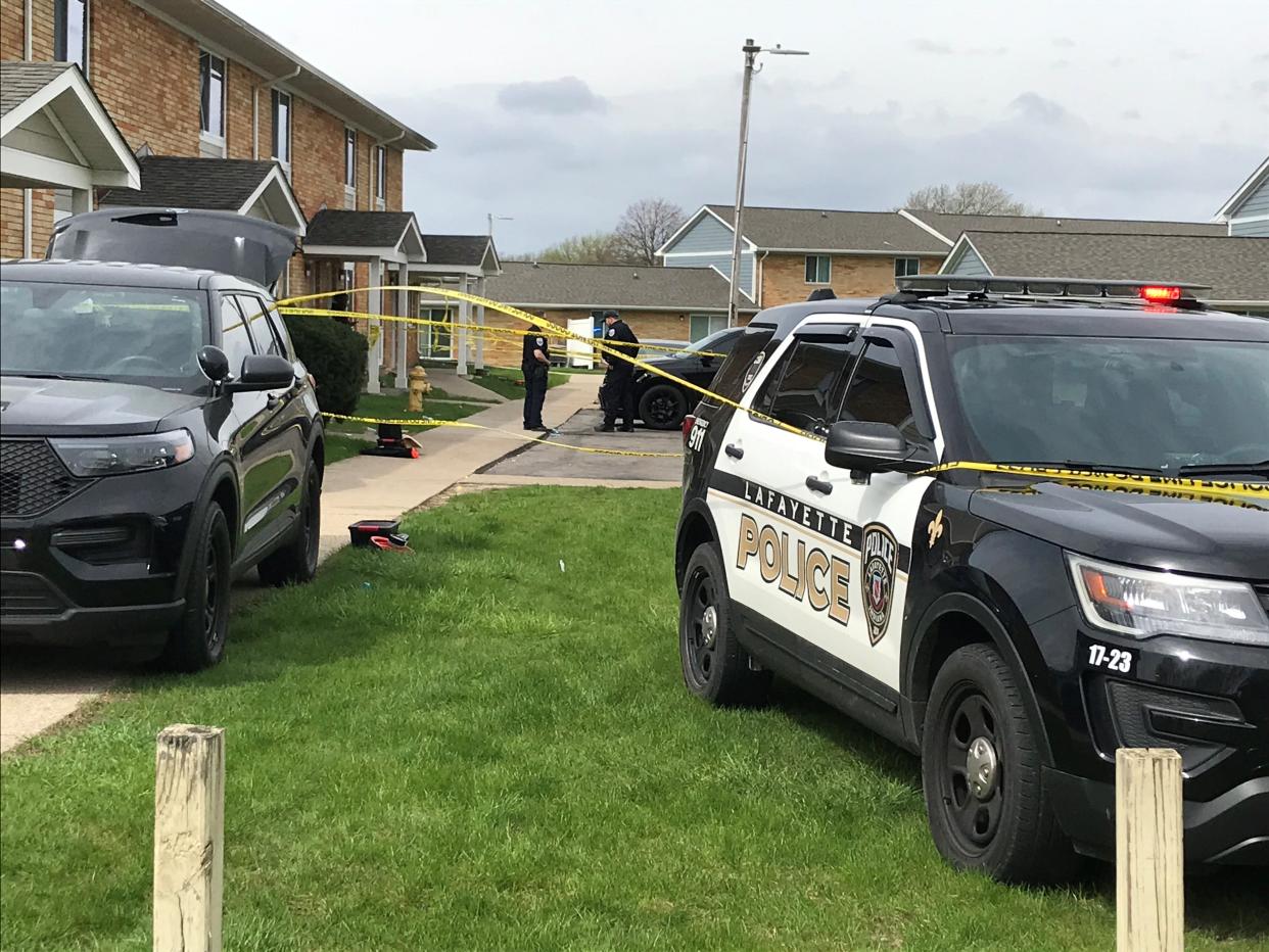 Lafayette police officers stand watch outside of the scene were two people died and four people were wounded as gunshots were exchanged early Sunday, April 24, 2022, at the south end of Phipps Court in Romney Meadows.