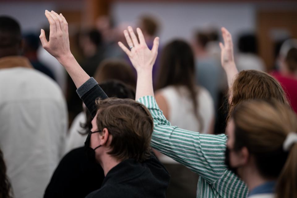 Congregation members hold their hands up during a service at Koinonia Church in Nashville, Tenn., Sunday, April 2, 2023.