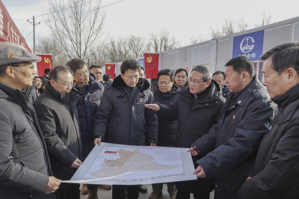 In this photo released by Xinhua News Agency, Chinese Premier Li Qiang, third right, talks to officials as he checks on the work related to resettlement, relief supplies during his visit to the earthquake hit Meiyi Village in Zhongchuan Township, Minhe County, northwest China's Qinghai Province on Dec. 23, 2023. The strong earthquake that hit northwest China and killed at least 148 people, has caused tens of millions of estimated economic losses in the agricultural and fisheries industries, state media reported Saturday, Dec. 23, 2023. (Yao Dawei/Xinhua via AP)