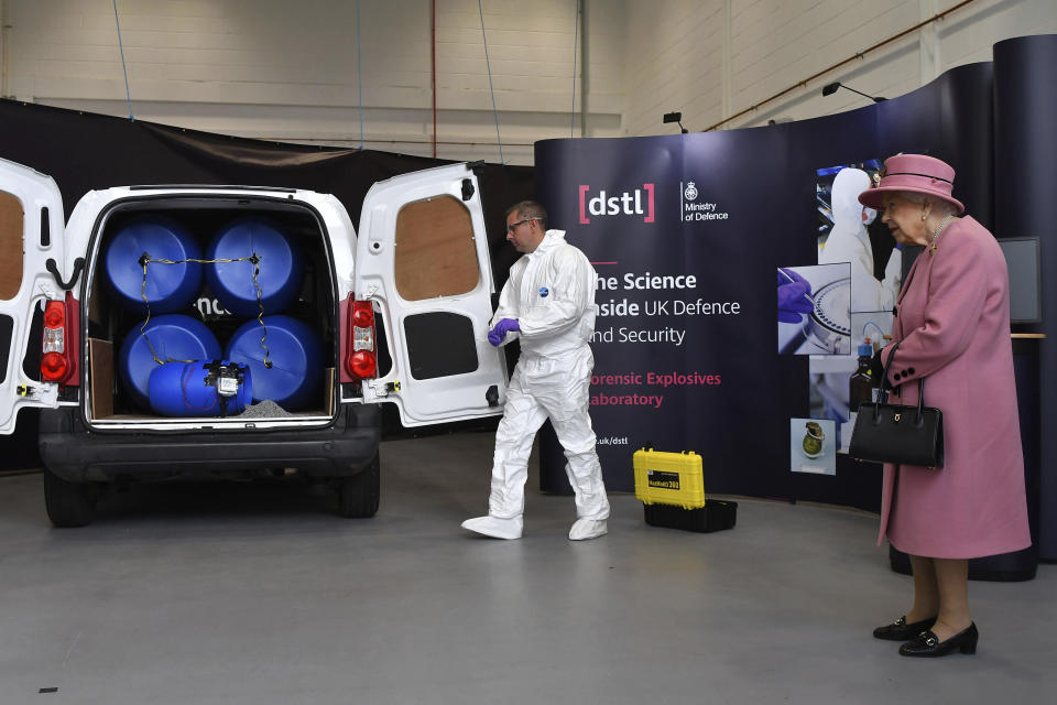 Britain's Queen Elizabeth II views a demonstration of a Forensic Explosives Investigation, with a model explosive device in a vehicle, during a visit to the Defence Science and Technology Laboratory (DSTL) at Porton Down, England, Thursday Oct. 15, 2020, to view the Energetics Enclosure and display of weaponry and tactics used in counter intelligence. (Ben Stansall/Pool via AP)