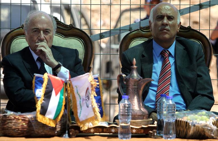 FIFA president Sepp Blatter (left) and Palestinian Football Association chief Jibril Rajoub speak to reporters near the West Bank city of Ramallah, on May 20, 2015