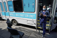 FILE — In this March 29, 2021, file photo, a health care worker steps out of a mobile vaccination van parked on a street corner in the Sunset Park neighborhood of Brooklyn, in New York. New York City hopes to begin offering coronavirus inoculations to tourists by stationing vaccination vans in Times Square and other visitor-heavy spots, Mayor Bill de Blasio said Thursday, May 6, 2021. (AP Photo/Kathy Willens, File)