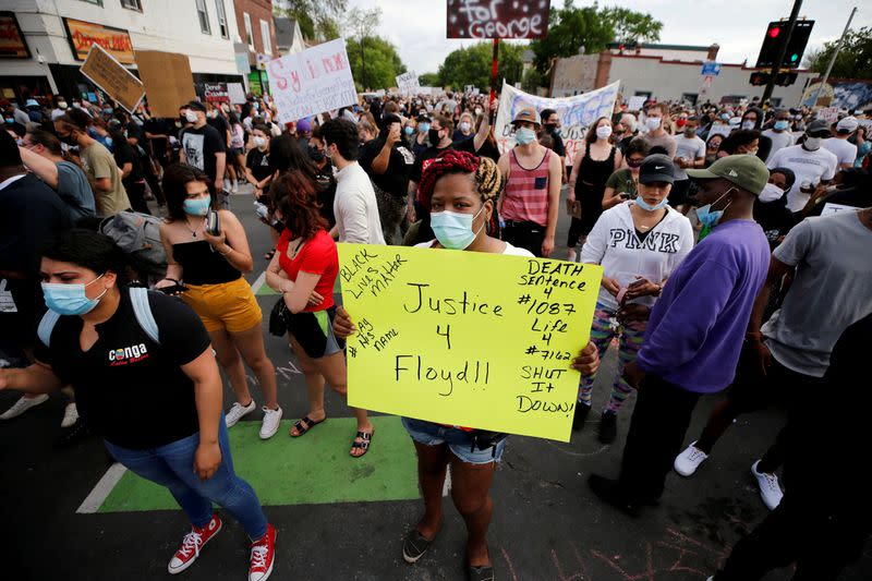 FILE PHOTO: Protesters gather at the scene where Floyd was pinned down by a police officer in Minneapolis