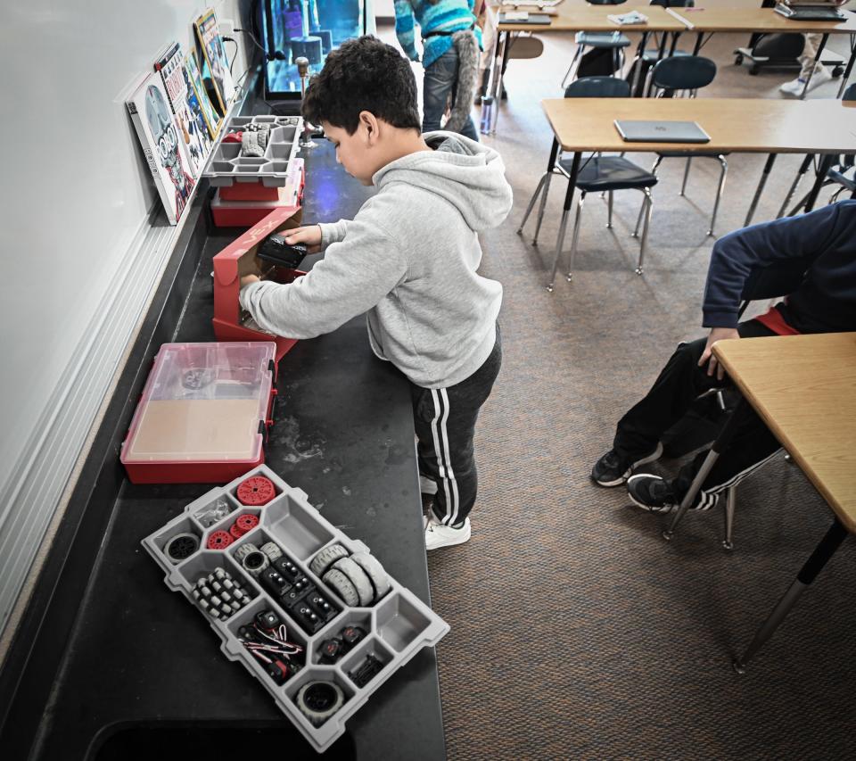 Sixth-grader Carlos Alvarez Vilanoba organizes robotic pieces, Wednesday, Nov. 29, 2023, during his robotics "enrichment" class at Hayes Intermediate School in Grand Ledge. There are more than 30 unique enrichment classes students may choose from based on their personal interests.