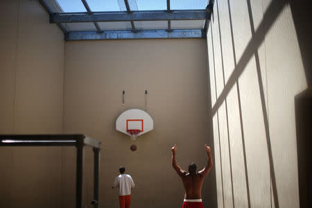 Detainees exercise in a recreation area at the Adelanto immigration detention center, which is run by the Geo Group Inc (GEO.N), in Adelanto, California, U.S., April 13, 2017. REUTERS/Lucy Nicholson SEARCH