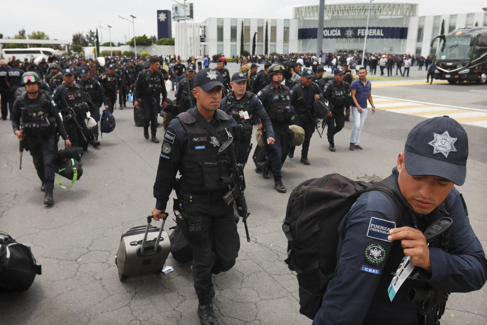 Uniformed Mexican federal police arrive to a police command center in the Iztapalapa borough of Mexico City, Wednesday, July 3, 2019, to protest plans to force federal police into the newly formed National Guard. Hundreds of Mexican federal police are in open revolt Wednesday against plans to absorb them into the newly formed National Guard, saying their seniority, rank and benefits are not being recognized within the National Guard. (AP Photo/Marco Ugarte)