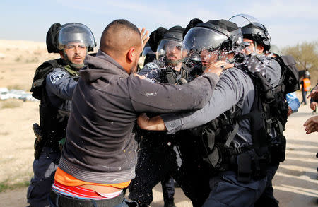 An Arab Israeli man clashes with Israeli riot policemen in Umm Al-Hiran, a Bedouin village in Israel's southern Negev Desert January 18, 2017. REUTERS/Ammar Awad