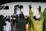 Former Gambian president Yahya Jammeh waves from the plane as he leaves the country he ruled for 22 years on 21 January 2017