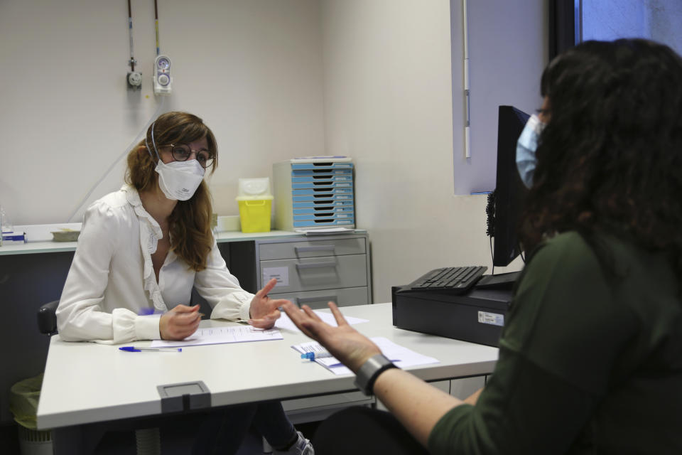 Dr. Louise-Emilie Dumas, a psychiatrist, talks with patient Gabriella Forgione during tests in a hospital in Nice, southern France, Monday, Feb. 8, 2021, to help determine why she has been unable to smell or taste since she contracted COVID-19 in November 2020. A year into the coronavirus pandemic, doctors and researchers are still striving to better understand and treat the accompanying epidemic of COVID-19-related anosmia — loss of smell — draining much of the joy of life from an increasing number of sensorially frustrated longer-term sufferers like Forgione. (AP Photo/John Leicester)