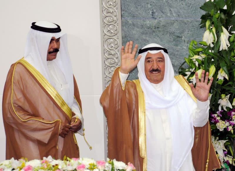 FILE PHOTO: Kuwait's Emir Sheikh Sabah waves at the start of the forth session of the 13th term of the parliament as Crown Prince Sheikh Nawaf stands to his side