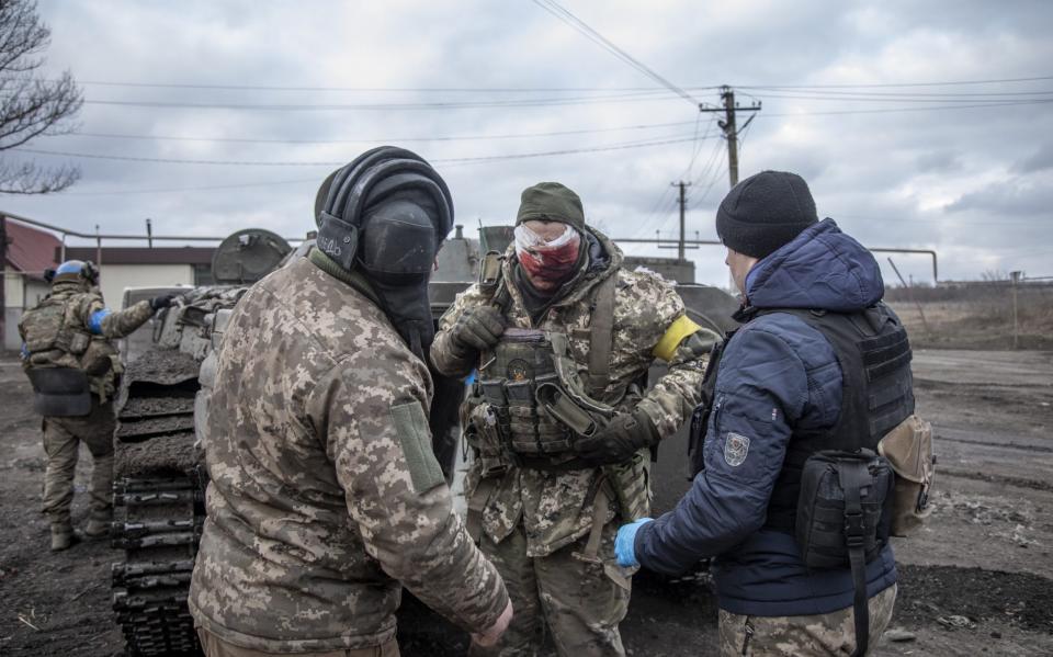 The Ukrainian serviceman's face is severely injured as he arrives at the evacuation point