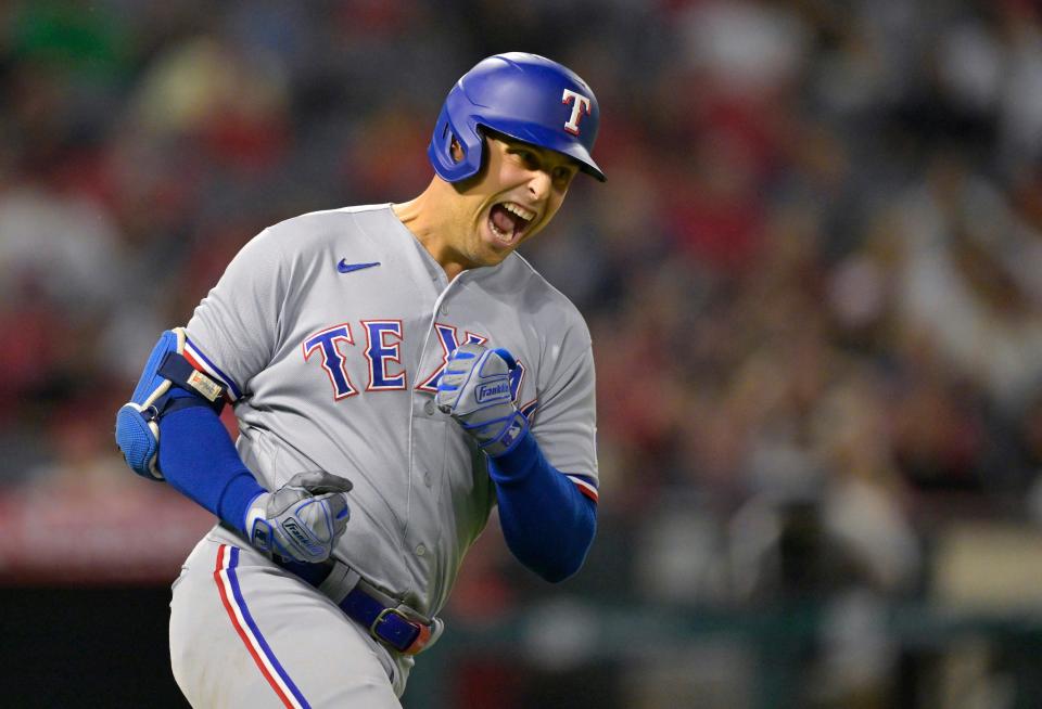 Rangers' Nathaniel Lowe reacts after hitting a home run against the Angels at Angel Stadium in Anaheim, Calif. on Sept. 25, 2023.