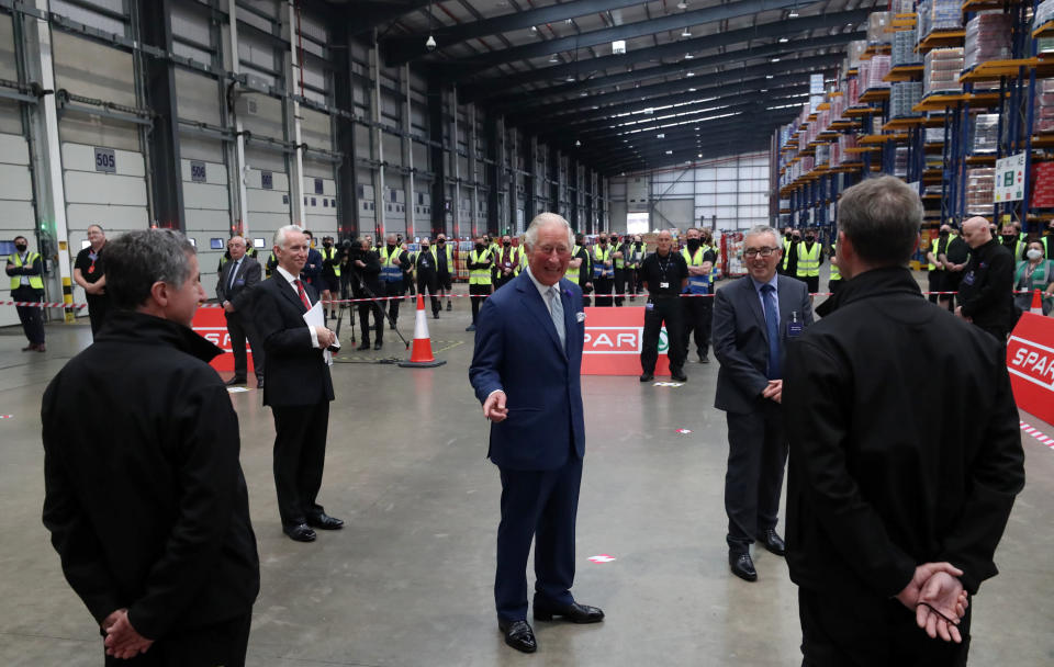 Britain's Prince Charles, Prince of Wales (C) reacts as he meets staff during a visit to Henderson Foodservice's food and grocery distribution centre in Newtownabbey, near Belfast, on September 30, 2020, where he thanked them for their efforts during the COVID-19 pandemic, and coping with the unprecedented demand they faced in recent months. (Photo by Niall Carson / POOL / AFP) (Photo by NIALL CARSON/POOL/AFP via Getty Images)