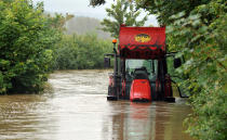 A tractor overwhelmed by flood water from the River Brit at Burton Bradstock, Dorset.