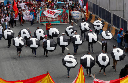 Activists display placards as they march near the House of Representatives to protest President Rodrigo Duterte's State of the Nation address in Quezon city, Metro Manila, in Philippines July 23, 2018. REUTERS/Erik De Castro