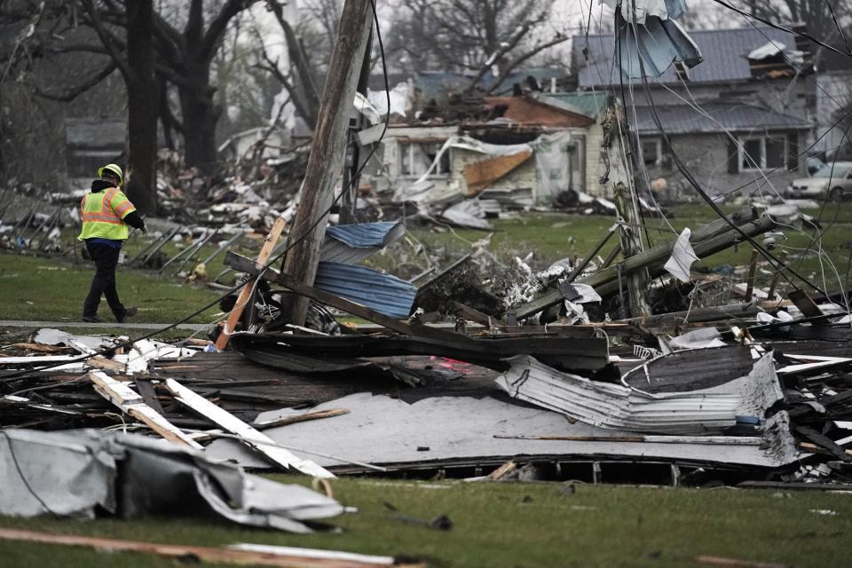 A worker checks on the power in the area following a severe storm Friday, March 15, 2024, in Lakeview, Ohio. (AP Photo/Joshua A. Bickel )