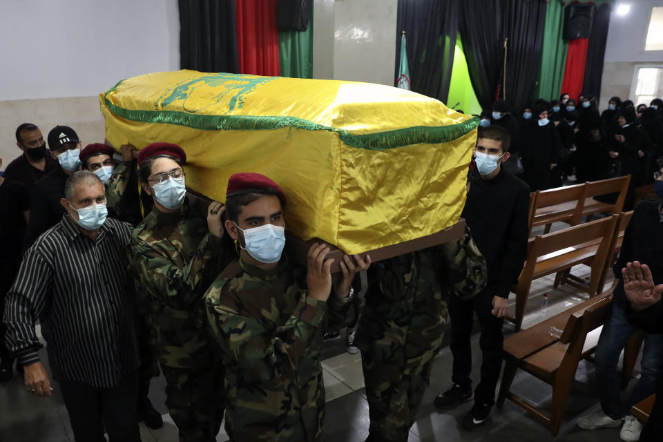 Hezbollah fighters carry the coffin of Ali Atwa, a senior Hezbollah operative, during his funeral procession in the southern Beirut suburb of Dahiyeh, Lebanon, Saturday, Oct. 9, 2021. Atwa was placed on the FBI's most wanted list in 2001, with two other alleged participants in the 1985 hijacking of TWA Flight 847, one of the worst hijackings in aviation history and that lasted for 16 days. (AP Photo/Bilal Hussein)