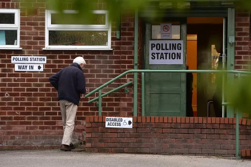 Voters arrives at the polling station at Newton Village  in the Wirral, Merseyside.