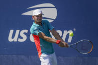 David Goffin, of Belgium, returns a shot to Filip Krajinovic, of Serbia, during the third round of the US Open tennis championships, Friday, Sept. 4, 2020, in New York. (AP Photo/Seth Wenig)