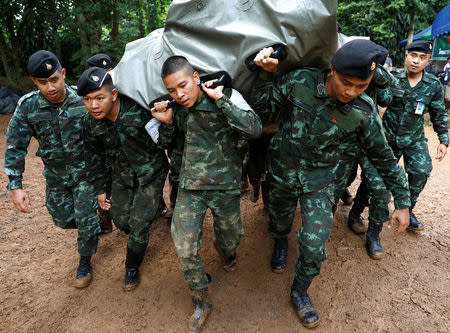 Soldiers unload aid supplies near the Tham Luang cave complex, as a search for members of an under-16 soccer team and their coach continues, in the northern province of Chiang Rai, Thailand, June 29, 2018. REUTERS/Soe Zeya Tun