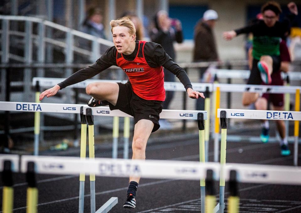 Wapahani's Drayden Gates competes in the 110-meter hurdles during the Delaware County championship meet at Delta High School Friday, May 7, 2021.