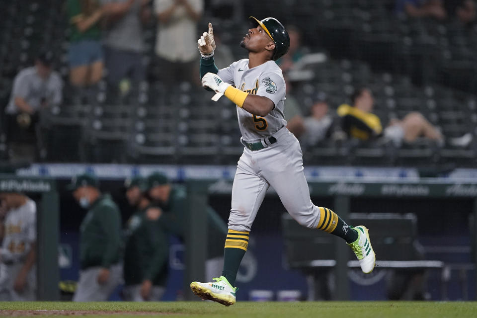 Oakland Athletics' Tony Kemp gestures as he nears home plate after hitting a two-run home run during the eighth inning of the team's baseball game against the Seattle Mariners, Tuesday, June 1, 2021, in Seattle. (AP Photo/Ted S. Warren)