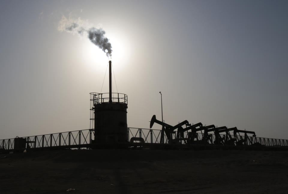 Oil pumps work at sunset Thursday, July 16, 2015, in the desert oil fields of Sakhir, Bahrain. Many analysts estimate that Iran has piled up tens of millions of barrels on floating barges that can be exported soon after sanctions have been lifted. So it's possible that once economic sanctions are lifted and Iran can sell more oil, crude oil prices could come down. (AP Photo/Hasan Jamali)