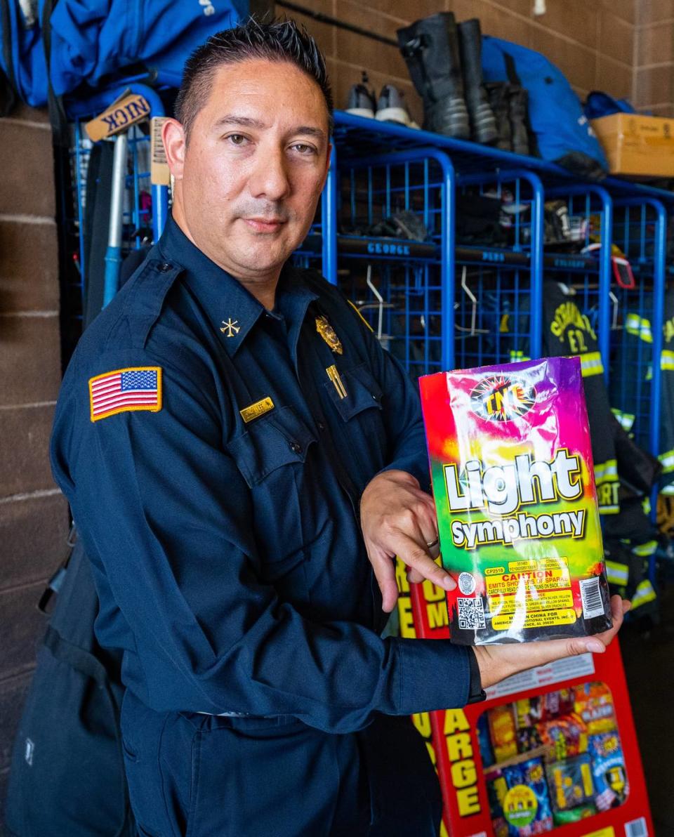 Sacramento Fire Marshal Jason Lee points to the “safe and sane” seal on an example of legal fireworks during a press conference on reporting illegal fireworks, June 22, 2022. The press conference took place at Sacramento Fire Station 10.