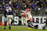 Kansas City Chiefs quarterback Patrick Mahomes, center, is pressured by Baltimore Ravens linebackers Justin Houston (50) and Odafe Oweh (99) in the first half of an NFL football game, Sunday, Sept. 19, 2021, in Baltimore. (AP Photo/Julio Cortez)