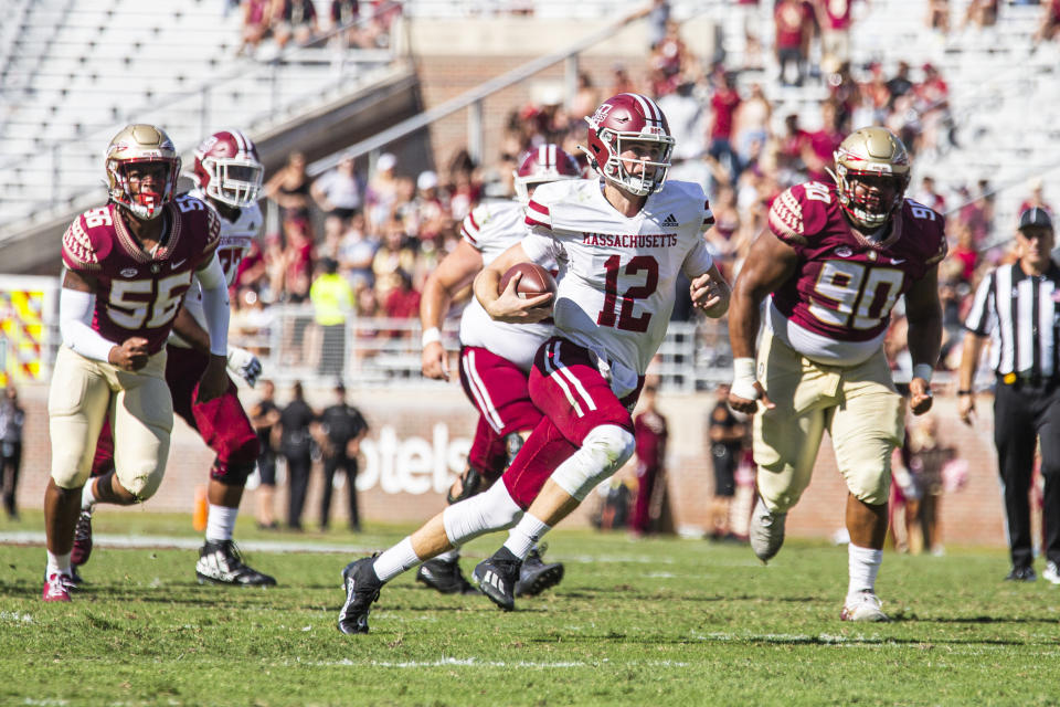 Massachusetts quarterback Brady Olson (12) scrambles for a long gain in the second half of an NCAA college football game against Florida State in Tallahassee, Fla., Saturday, Oct. 23, 2021. Florida State defeated UMass 59-3. (AP Photo/Mark Wallheiser)
