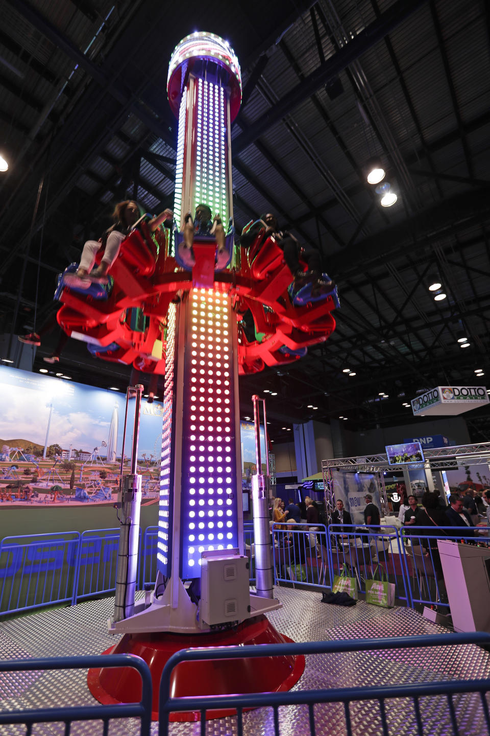 Attendees sample one of the many rides on display at the International Association of Amusement Parks and Attractions convention Tuesday, Nov. 19, 2019, in Orlando, Fla. (AP Photo/John Raoux)