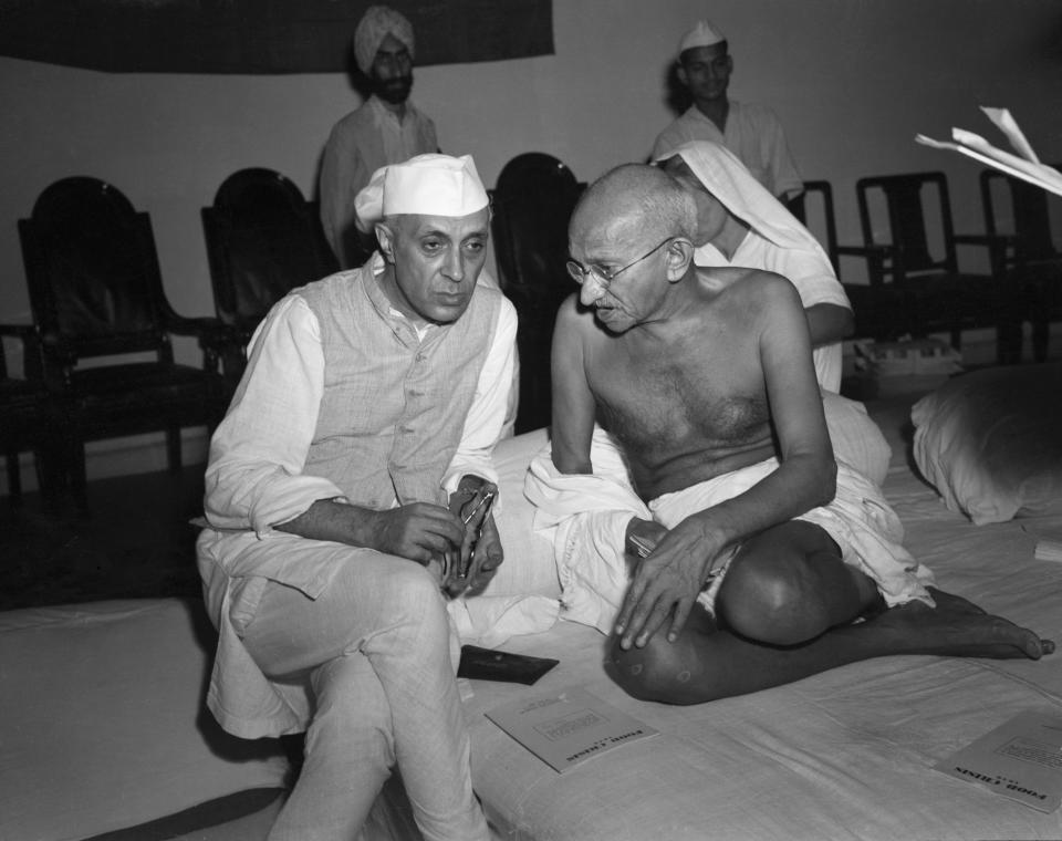 (Original Caption) 1946-Bombay, India: The architect of India's independence from Great Britain, Mahatma Gandhi (right) talks to his eventual successor, Rashtrapati Jawaharlal Nehru in 1946. Gandhi's name has become synonymous with non-violent opposition and political leverage, and his struggle in india has served as a model for political struggles around the world. BPA2 #2839