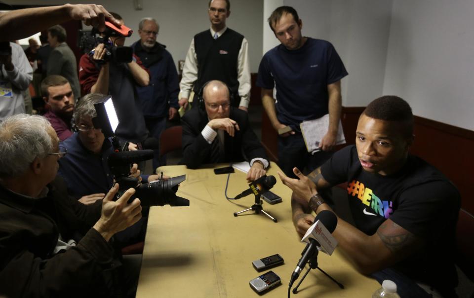 University of Massachusetts basketball guard Derrick Gordon, 22, right, faces reporters on the school's campus, Wednesday, April 9, 2014, in Amherst, Mass. Gordon has become the first openly gay player in Division I men's basketball. (AP Photo/Steven Senne)