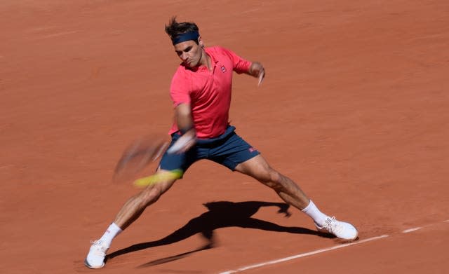 Roger Federer slides into a forehand