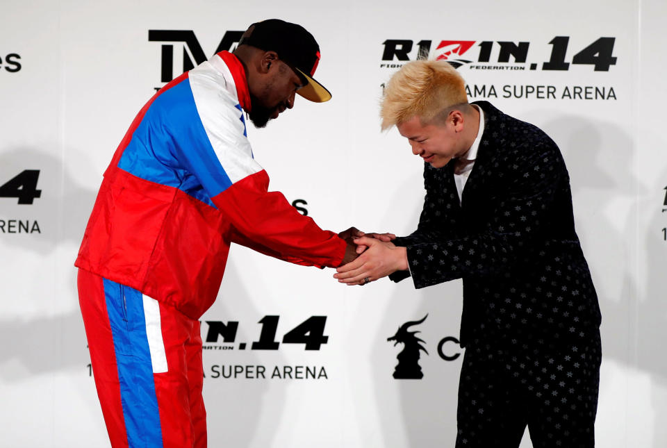 Floyd Mayweather Jr. shakes hands with his opponent Tenshin Nasukawa during a news conference in Tokyo on Nov. 5, 2018. (Reuters)