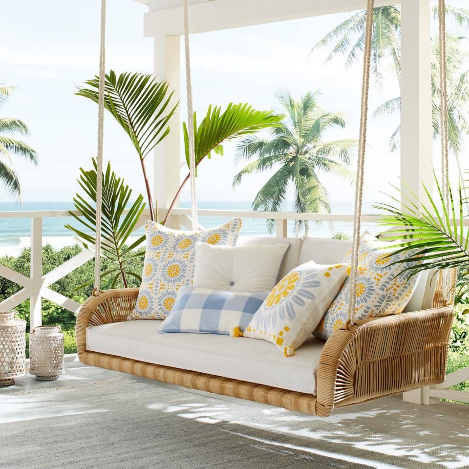 The Springwood Hanging Daybed on a veranda by the sea
