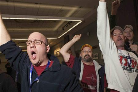 Union members celebrate after hearing the results of a union vote at the International Association of Machinists District 751 Headquarters in Seattle, Washington November 13, 2013. REUTERS/David Ryder