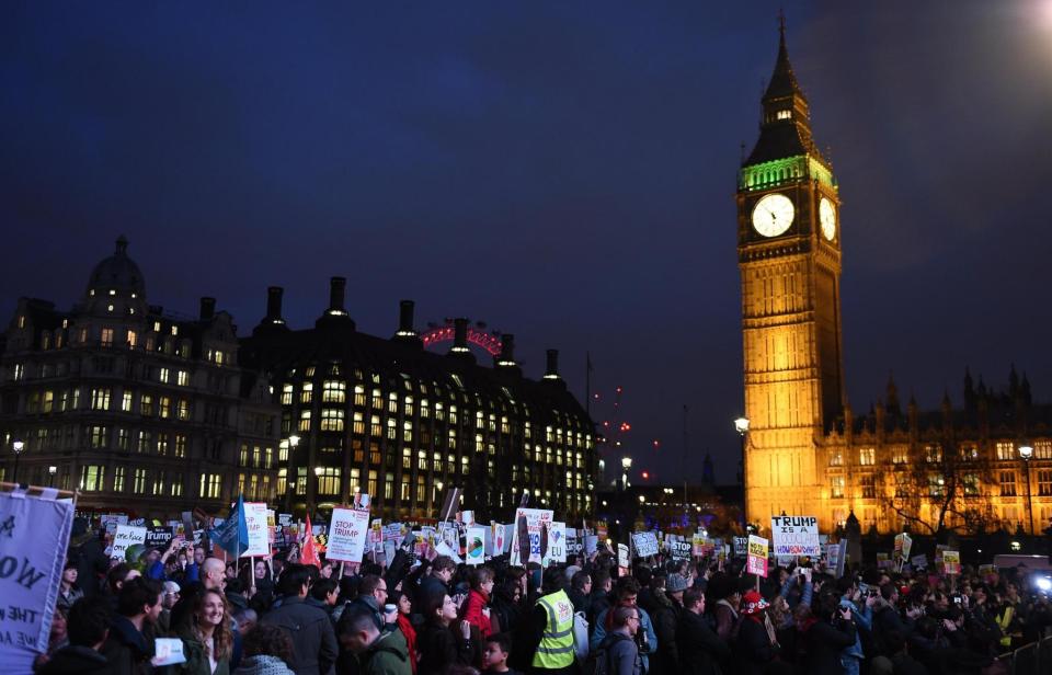 Protesters carrying colourful placards and banners gathered in the square shortly before 4pm (EPA)