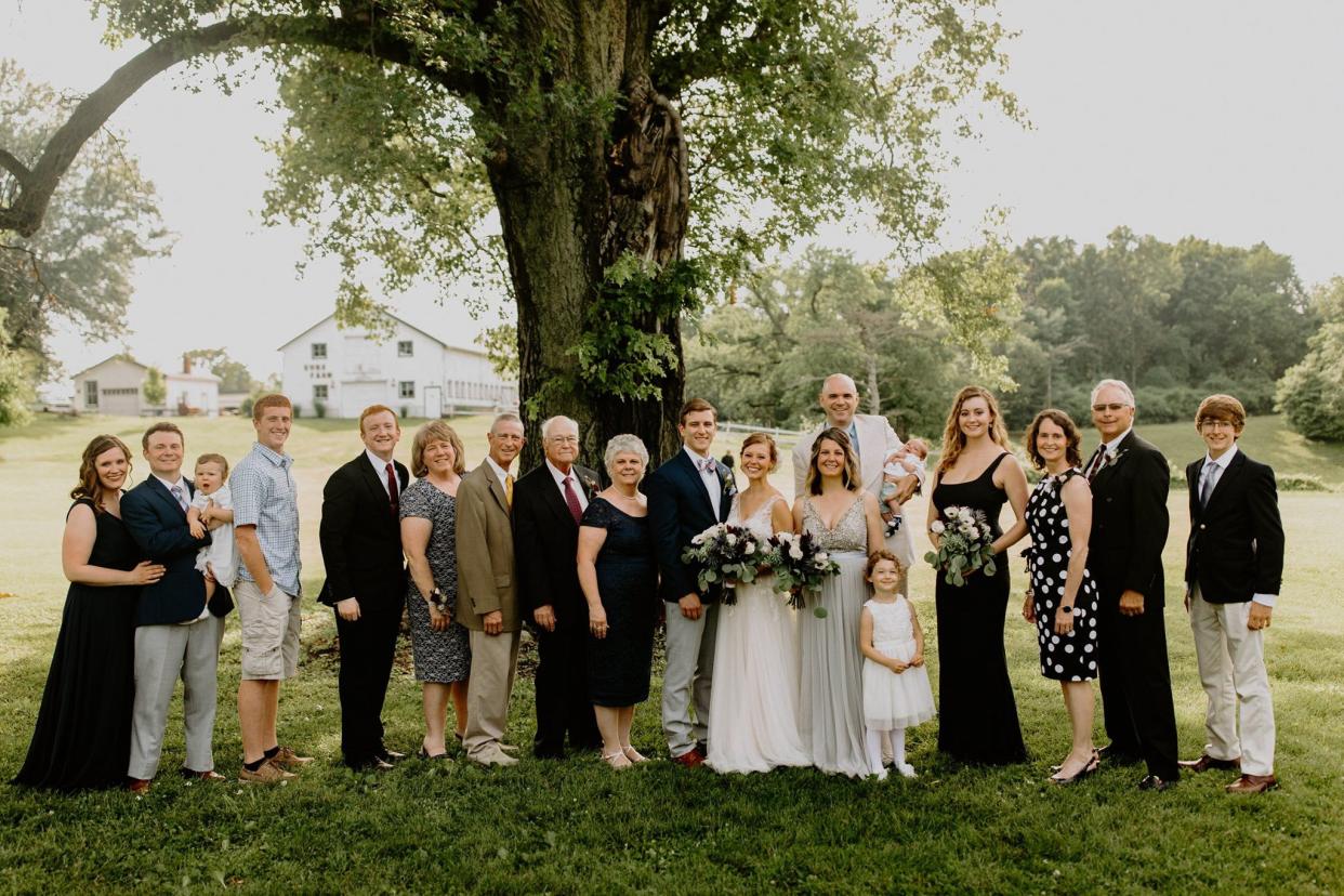 The Glenn family is pictured at a wedding in 2019 in St. Louis. St. Cloud Times sports reporter Reid Glenn stands fifth from right in a black suit.