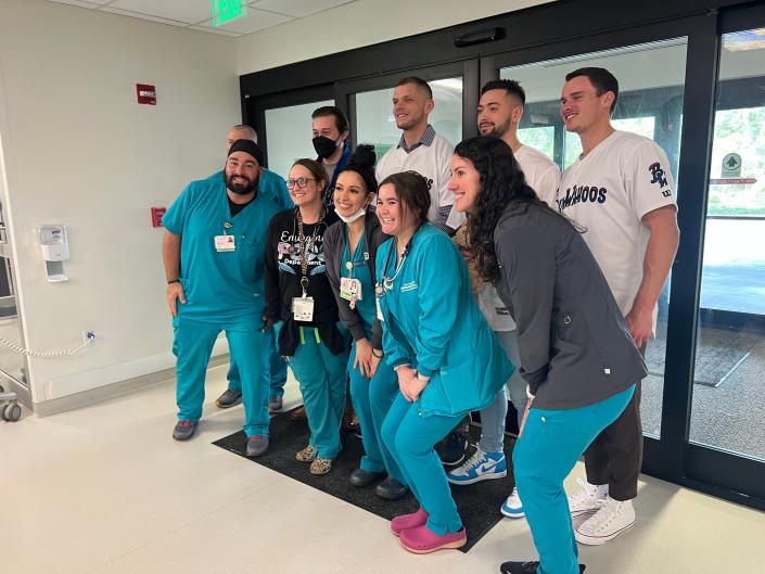 Blue Wahoos' Griffin Conine (far right), along with Will Banfield and new hitting coach Matt Snyder, join with hospital nurses and doctors Jan. 19 during visit to the Studer Family Children's Hospital at Ascension Sacred Heart as part of Fish Fest Event.