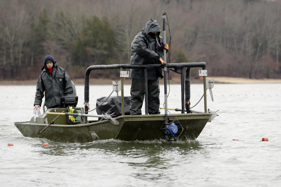 In this Feb. 5, 2020, photo, wildlife officials use pulses of electricity and sound to herd schools of Asian carp toward nets during a roundup in Smith Bay on Kentucky Lake near Golden Pond, Ky. The roundup is part of a 15-year battle to halt the advance of the invasive Asian carp, which threaten to upend aquatic ecosystems, starve out native fish and wipe out endangered mussel and snail populations along the Mississippi River and dozens of tributaries. (AP Photo/Mark Humphrey)