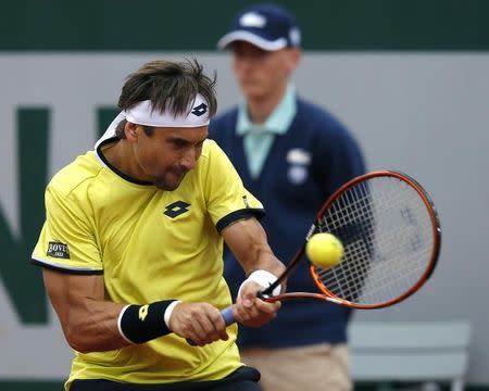 David Ferrer of Spain plays a shot to Lukas Lacko of Slovakia during their men's singles match at the French Open tennis tournament at the Roland Garros stadium in Paris, France, May 26, 2015. REUTERS/Gonzalo Fuentes