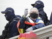 Demonstrator wear protective face masks during a protest a church where they were protesting church support for tightening Poland's already restrictive abortion law in Warsaw, Poland, Sunday, Oct. 25, 2020. Poland constitutional court issued a ruling on Thursday that further restricts abortion rights in Poland, triggering four straight days of protests across Poland.(AP Photo/Czarek Sokolowski)