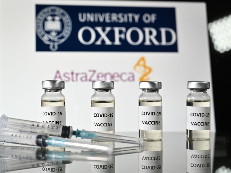 <p>An illustrative picture shows vials with Covid-19 vaccine stickers attached and syringes, with the logo of the University of Oxford and AstraZeneca</p> (AFP via Getty Images)