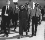 <p>Charles Manson is escorted by officers en route to court in Independence, Calif., on Dec. 3, 1970. Manson and three women co-defendants were convicted and sentenced to death after the 10-month trial that involved the murders of actress Sharon Tate and six others in the hills near Hollywood, Calif. Their sentences were later commuted to life when the death penalty was briefly outlawed. (Photo: AP) </p>