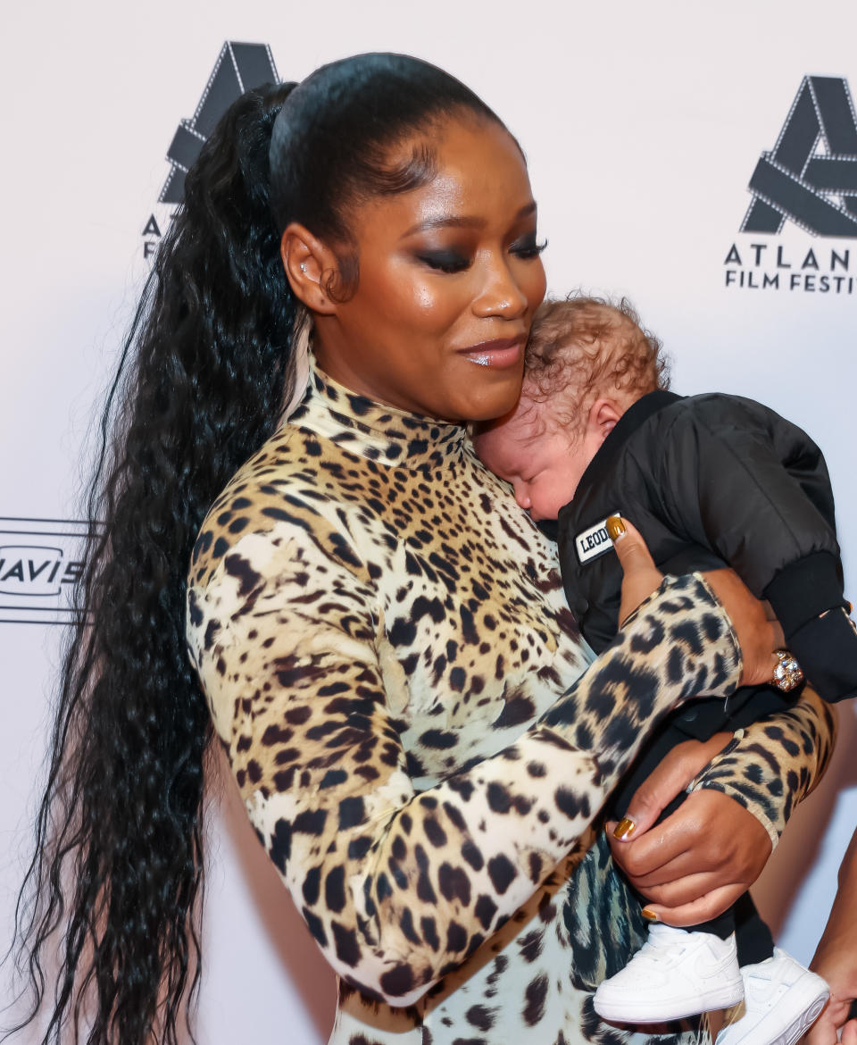 Keke holding her baby