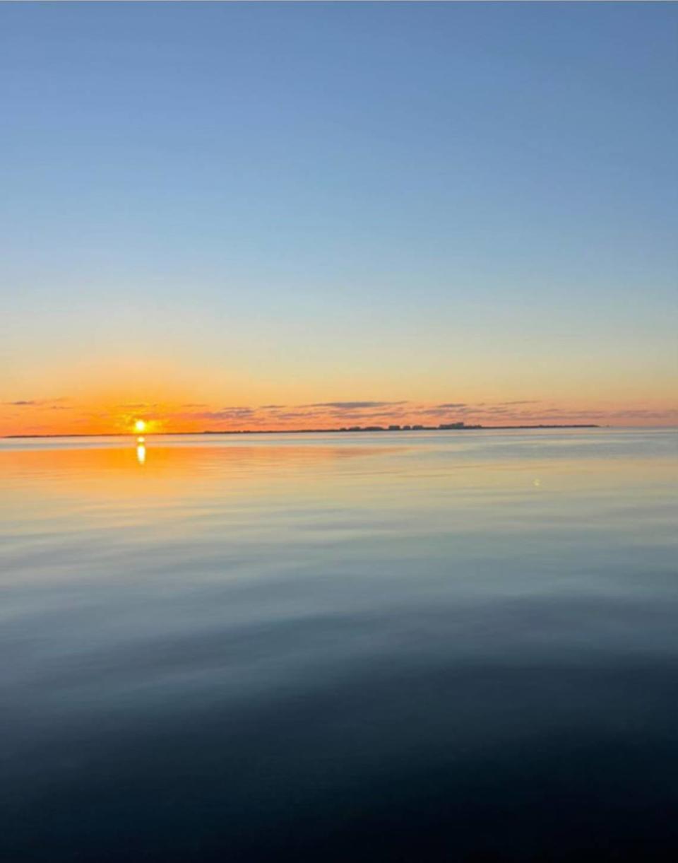 A view of the sunrise from the balcony of Grove Isle condo owner Wendy Gordon before construction of the seven-story Vita condo building began.