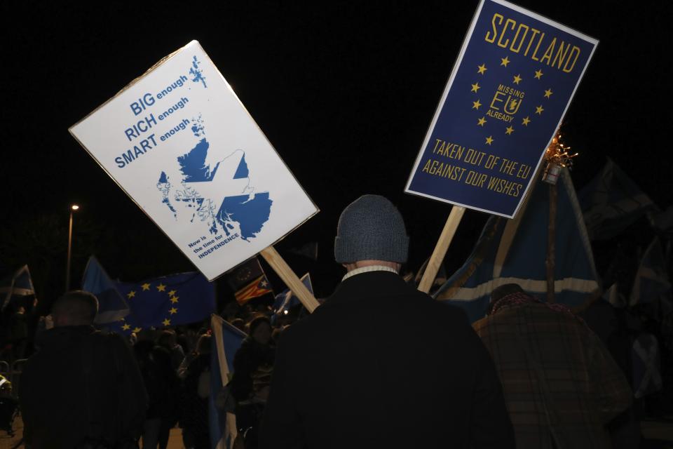 Anti-Brexit protesters gather outside the Scottish parliament in Edinburgh, Friday, Jan. 31, 2020. Britain officially leaves the European Union on Friday after a debilitating political period that has bitterly divided the nation since the 2016 Brexit referendum. (AP Photo/Scott Heppell)