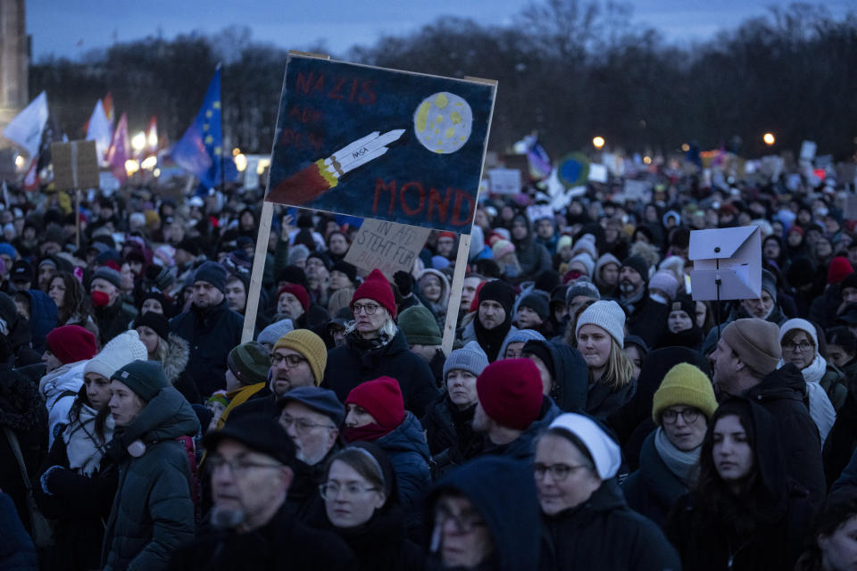 People gather as they protest against the AfD party and right-wing extremism in front of the Reichstag building in Berlin, Germany, Sunday, Jan. 21, 2024. (AP Photo/Ebrahim Noroozi)