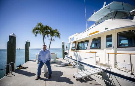 Former Air Force C-130 pilot Brian Hall, a businessman who wants to start 4-hour round trip service between Marathon in the Florida Keys and Havana, poses for or a picture in the the Marathon Marina in Marathon, Florida February 20, 2015. REUTERS/Mark Blinch